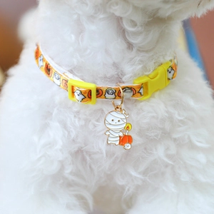 Close-up of orange Halloween pet collar with mummy pendant on a white dog
