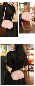 Close-up of pink shell-shaped bag with V-quilted pattern and pearl pendant detail