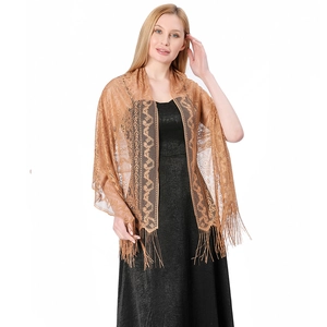 Detailed close-up of golden brown lace shawl with intricate paisley embroidery and long fringe