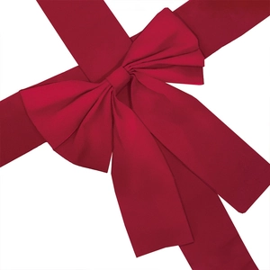 Close-up of large red Christmas ribbon bow with textured satin fabric for holiday decor