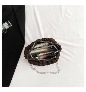 Internal view of brown pleated chain bag showing capacity for phone and cosmetics