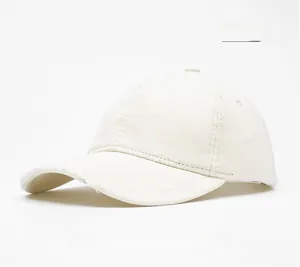 Detailed view of beige cotton baseball cap with twill texture and curved brim
