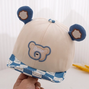 Close-up of baby bear cap with 3D ears, bear embroidery and checkered wavy brim detail