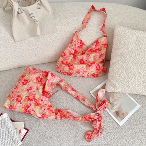 Detail of floral tote bag with silk texture and decorative bow in summer floral print