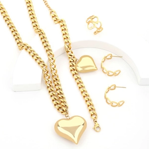 Detailed close-up of golden stainless steel heart jewelry set including necklace and earrings