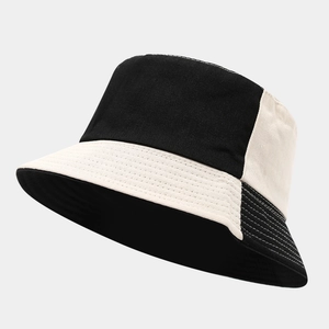 Detailed view of reinforced stitching on a black and beige two-tone cotton bucket hat
