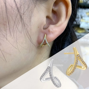 Macro shot of 18K gold plated multi-claw stud earrings with micro-pave cubic zirconia crystals