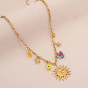 Detail of gold-plated stainless steel necklace with sun and evil eye charms