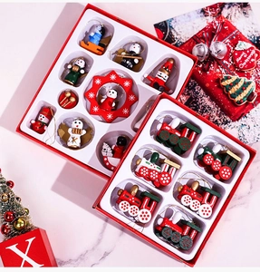 Detail of wooden Christmas ornaments set featuring mini trains and Santa in a red gift box