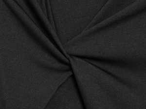 Detailed close-up of the black elastic fabric texture and elegant knot design on a skirt