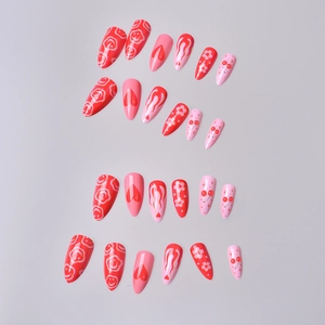 Y2K almond press-on nails featuring red hearts, cherry patterns, and pink flame designs