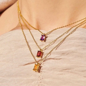 Three minimalist 18K gold plated necklaces featuring rectangular zircon birthstone pendants