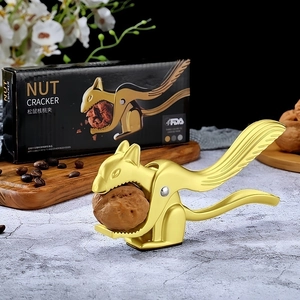Macro shot of squirrel nut cracker in golden finish with premium packaging box