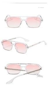 Detail view of transparent square sunglasses with gradient pink lenses and metal temples