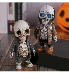 Detail of cartoon resin skeleton figurines in green and brown hoodies for Halloween decor