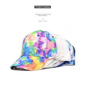 Detail view of tie-dye baseball caps with six-panel structure and reinforced stitched brims