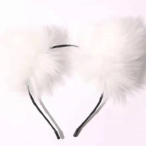 Close-up of white plush cat ear headband with soft faux fur and metal frame details