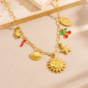 Gold stainless steel necklace with sun, starfish, shell and red chili charms on stone