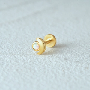 Macro view of a 16G gold flat back crescent ear stud with iridescent white opal inlay