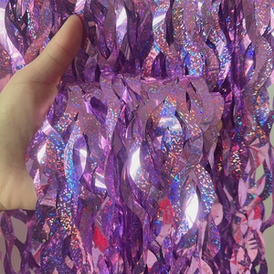 Macro detail of purple holographic S-shaped fringe curtain with sparkling glitter effect