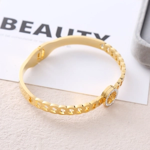 Gold plated stainless steel open bangle with tree of life charm and sparkling crystals