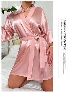 Close-up of pink satin robe showing smooth fabric texture and belted waist with tassels