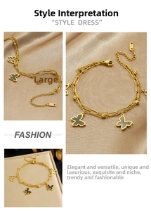 Detail of double-layer gold plated stainless steel bracelet with black butterfly charms