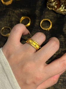 Detail shot of a vintage gold-toned ring with star sun patterns and zircon stones
