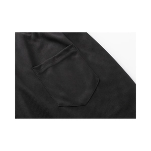 Detail of black mesh breathable fabric and reinforced pocket stitching on men's shorts