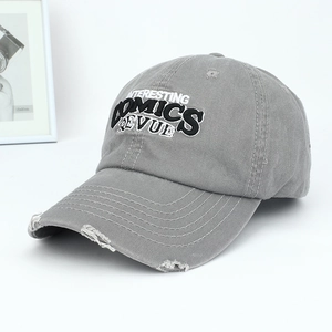Close-up of vintage washed grey cotton baseball cap with distressed details and embroidery