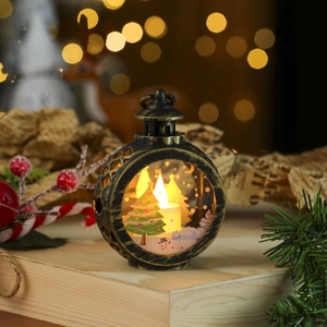 Detail of vintage bronze Christmas lantern with LED candle and festive snow scene