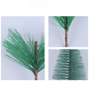 Detail showing dense green artificial pine needles and realistic brown branch texture