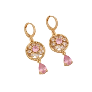 Vintage hollow gold drop earrings with pink gemstones and floral accents in professional studio lighting