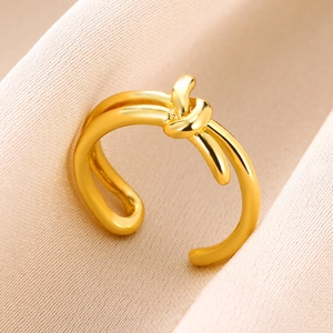 Detailed macro view of the gold-plated double-line knot ring on elegant velvet