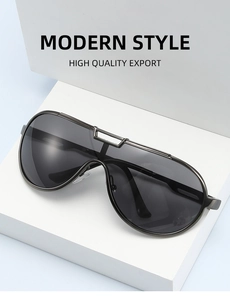 Detailed view of dark grey integrated metal frame sunglasses on a white block