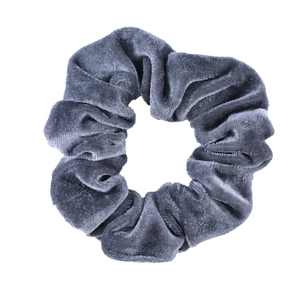 Close-up of a soft dark gray velvet scrunchie showing fine texture and plush fabric folds