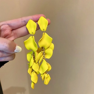 Detailed view of yellow matte flower petal tassel earrings with long drop dangle