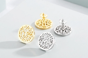 Detailed view of hollow scroll pattern stud earrings in gold and silver stainless steel