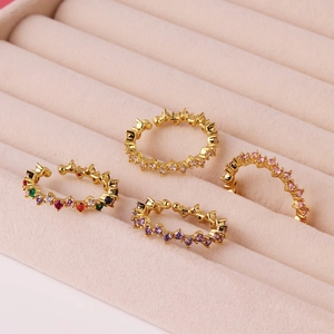 Close-up of gold-plated rings with colorful cubic zirconia in a pink velvet jewelry box