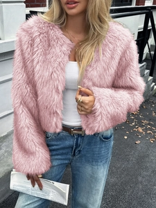 Detail of a pink faux fur short coat featuring plush texture and long sleeves in sunlight