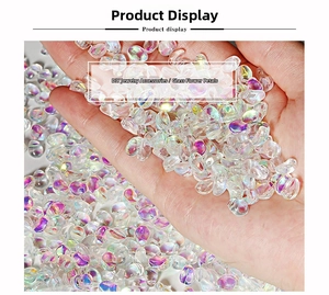 Iridescent glass tulip petal beads for DIY jewelry held in hand showing opal finish