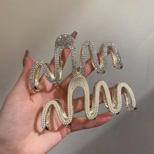 Golden wave hair claw clip set with white crystals and pearls for elegant hairstyles