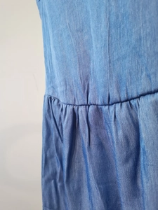 Detailed view of waist pleats and fabric texture on a blue summer dress for women