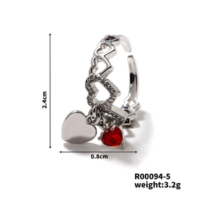 Detail view of heart-shaped adjustable silver ring with red zircon stone and dimensions