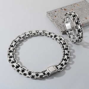 Close-up of 316L stainless steel X-shaped hollow link chain necklace and bracelet set