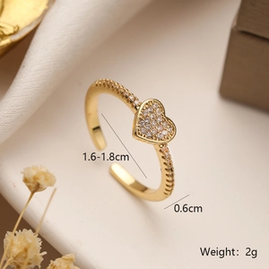 Macro view of gold heart ring with pavé zircons and detailed measurement markings