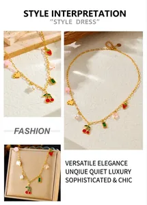 Detailed view of gold stainless steel necklace with cherry, strawberry and pearl charms