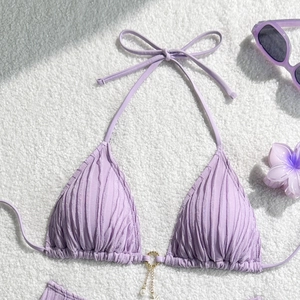 Detail of lavender textured bikini top with golden ring and pearl chain pendant decoration