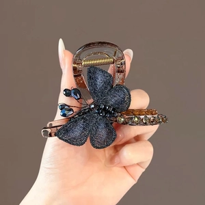 Blue mesh butterfly hair claw with dark beads on translucent brown acrylic base