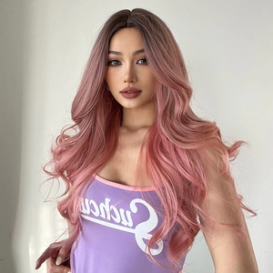 Detail shot of long wavy wig in rose gold pink ombre style worn by a professional model
